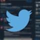 twitter logo on dark background with tweets